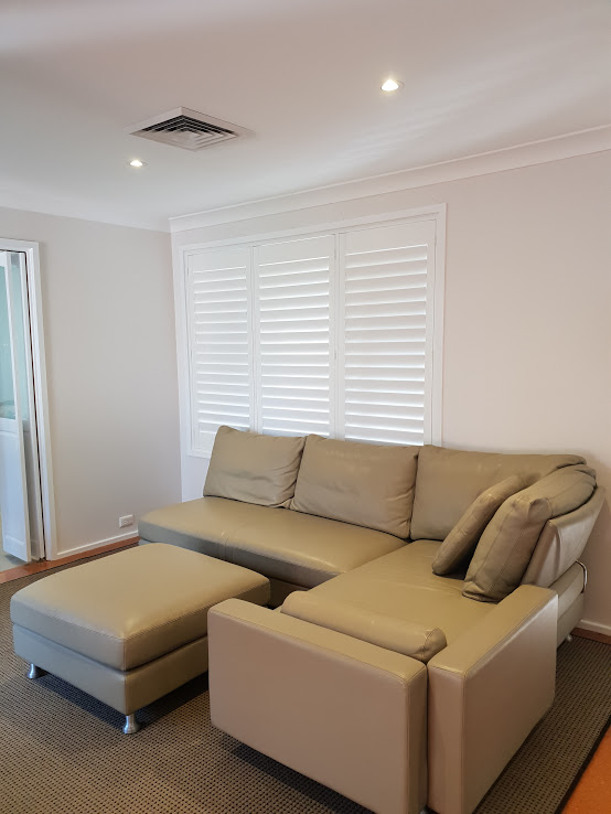 Shutters in a room with sofa and mini table sofa